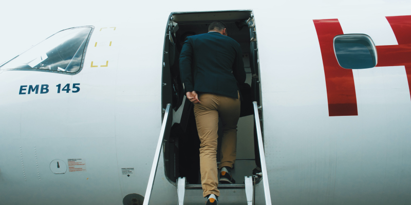photo of a man boarding a plane